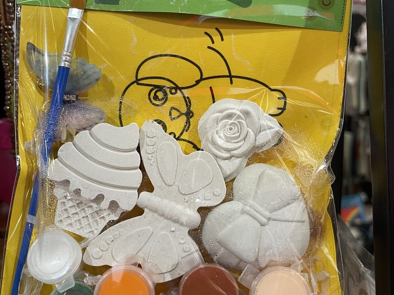 A hand-painted plaster kit with paint pots and brush
