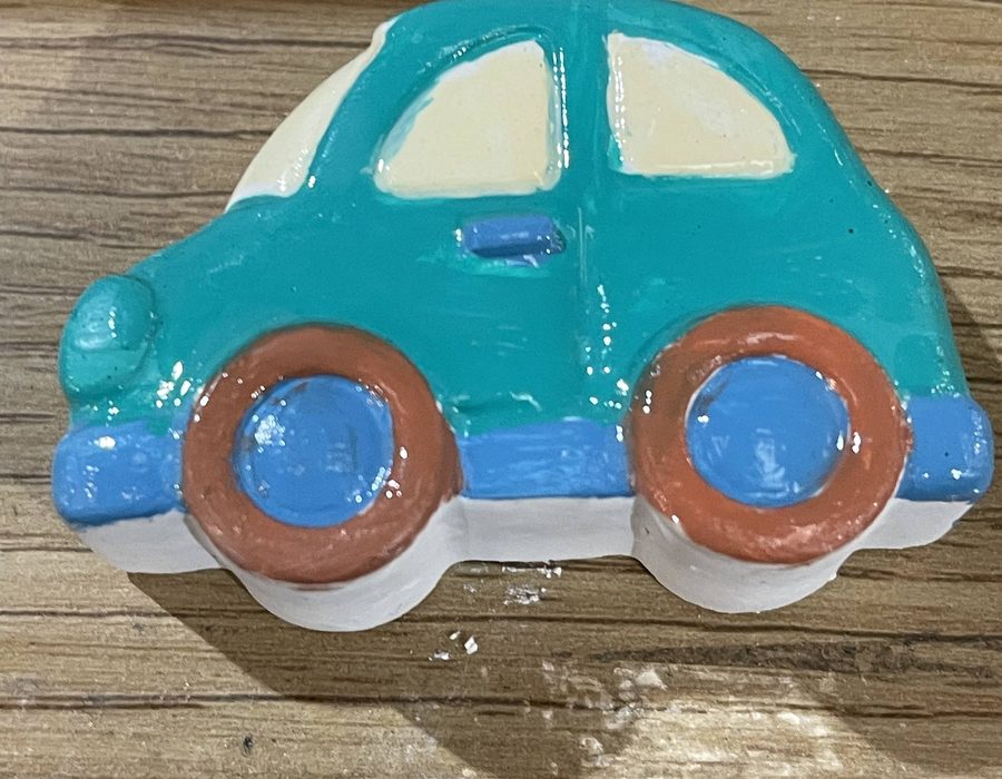A finished hand-painted teal car fridge magnet
